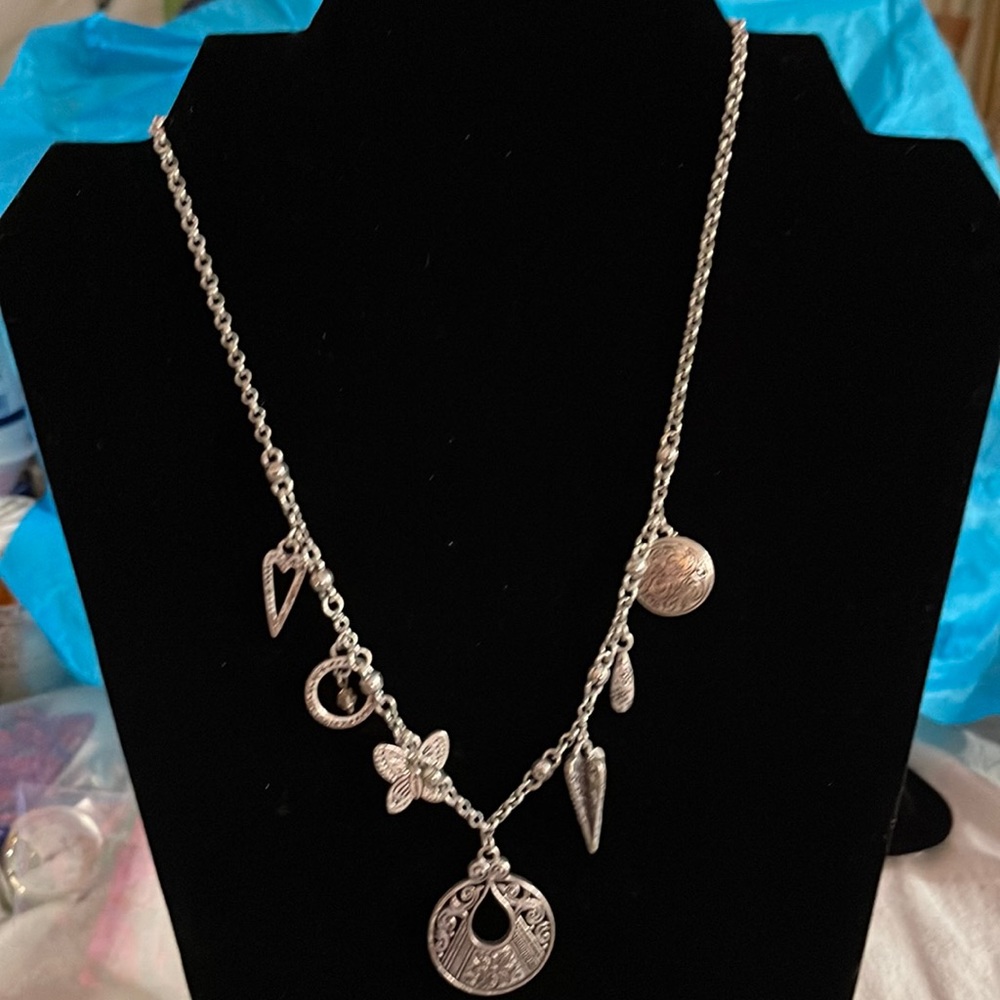 BRIGHTON NECKLACE WITH 7 DIFFERENT CHARMS 16 INCH LONG.